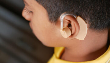 Hearing aid concept teenage boy with hearing problems